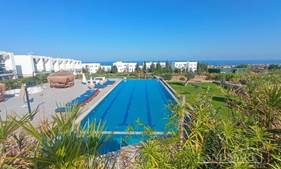 2-bedroom resale garden apartment + fully furnished + communal swimming pools + indoor swimming pool + gym + sauna + steam room + Pilates and yoga room + restaurant + on-site generator + walking distance to the beach + fabulous sea and mountain views